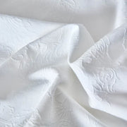 Close-up of Bianca duvet cover medallion texture showing detailed woven pattern and rich matelassé finish